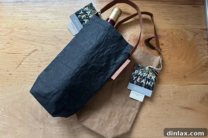 A selection of stylish paper wine totes, each holding a bottle of wine, presented against a clean backdrop, highlighting their elegant design and functionality.