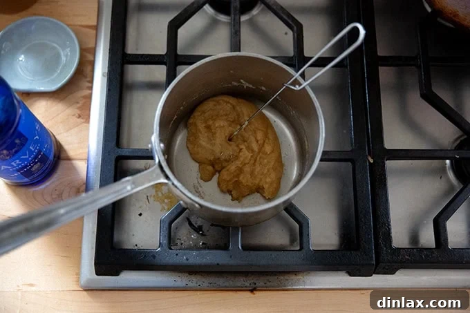 The roux and Sherry mixture in a small saucepan, now thoroughly whisked together and simmering gently on the stovetop.