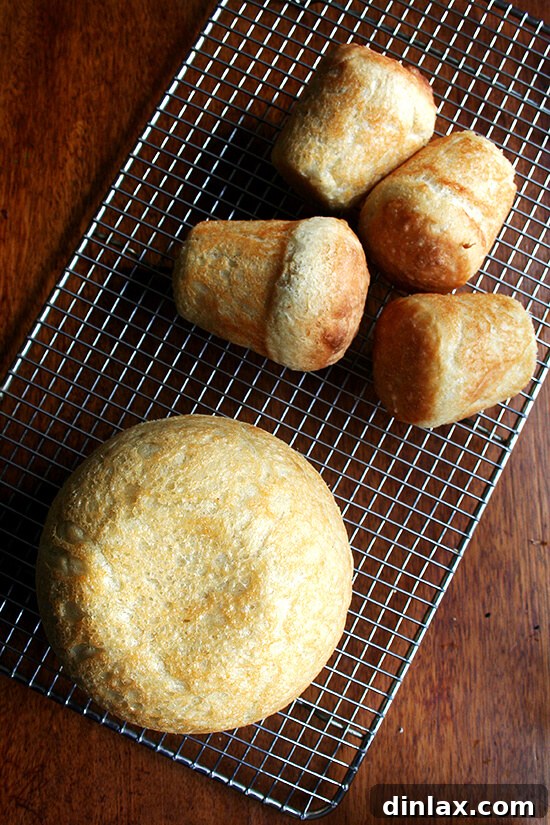Paul Steindler's Cabbage Soup and Peasant Bread: A Hearty Duo 13 A full-sized peasant bread loaf complemented by smaller mini loaves, highlighting the various ways this delicious bread can be enjoyed.