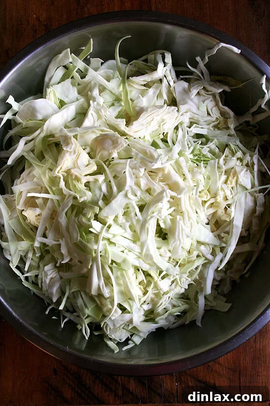Paul Steindler's Cabbage Soup and Peasant Bread: A Hearty Duo 6 A large bowl filled with 14 cups of freshly shredded cabbage, ready for blanching.