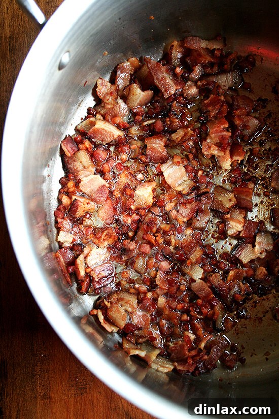 Paul Steindler's Cabbage Soup and Peasant Bread: A Hearty Duo 8 Bacon crisping in a pot, rendering its fat to create a flavorful base for the cabbage soup.