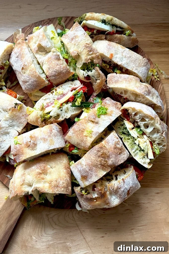 Sliced giant sandwiches on a board, ready for serving.