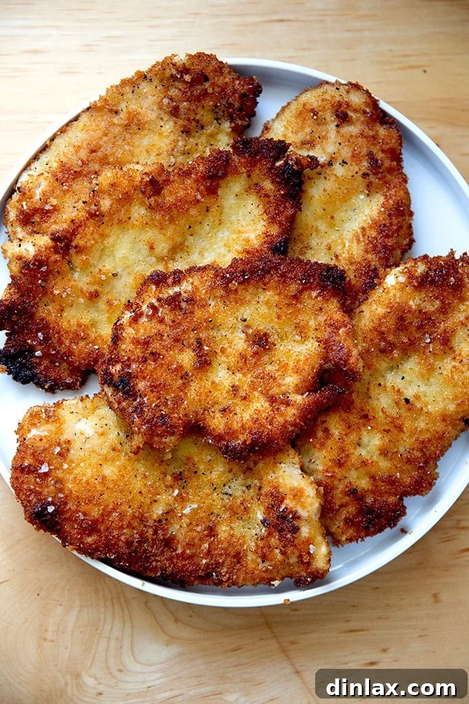 Just-cooked chicken cutlets on a plate.