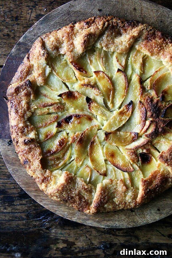 An apple-frangipane galette on a board.