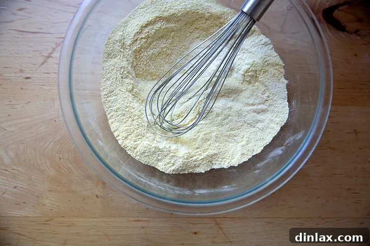 The dry ingredients to make cornbread all whisked together in a large bow.